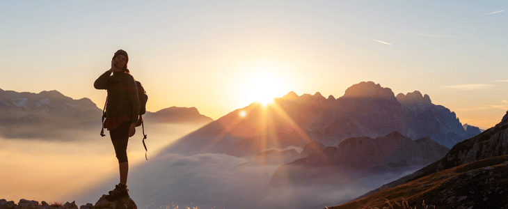 Hiker poses on top of mountain